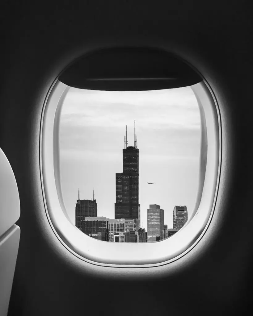 airplane window with city outside