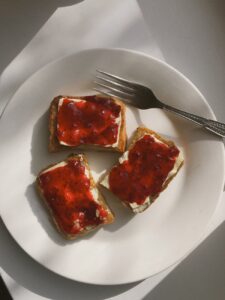 toasted bread slices with jam for brunch laying on plate